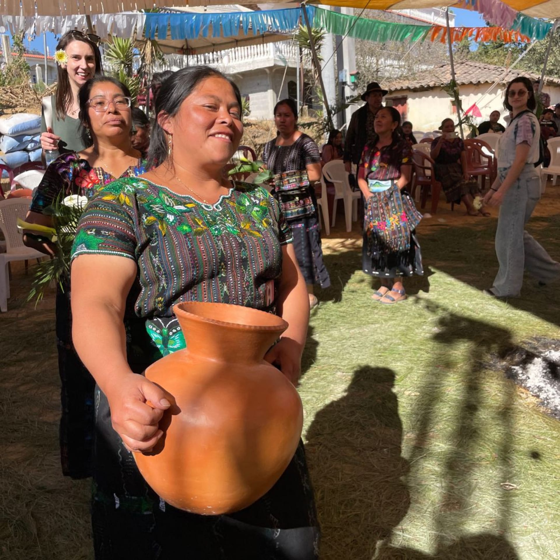 a group of women holding a pot