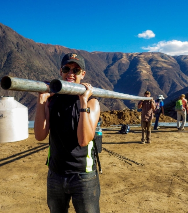 a person holding a metal pipe