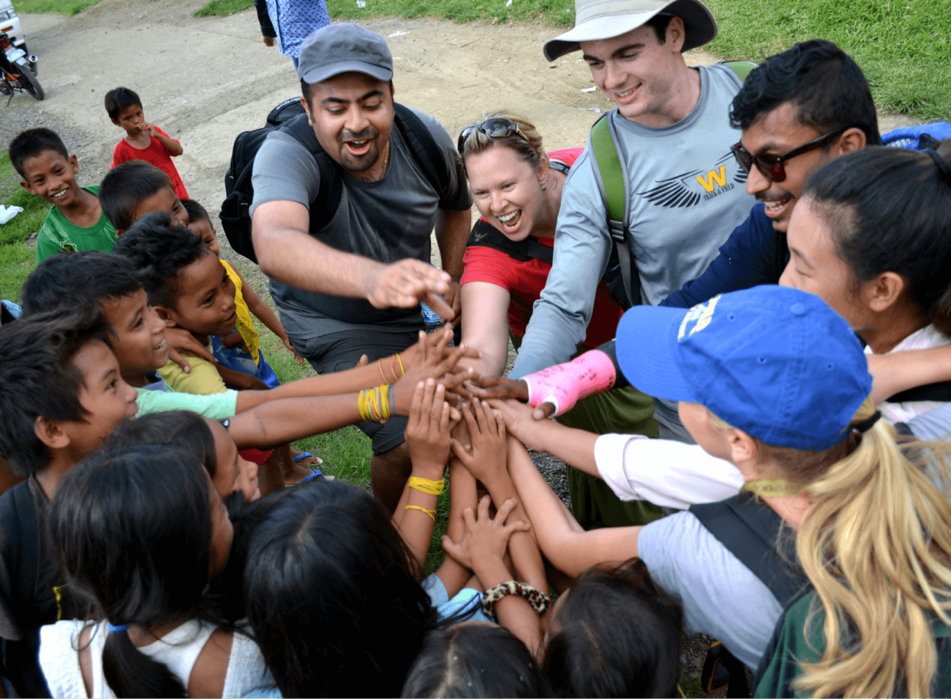 a group of people putting their hands together