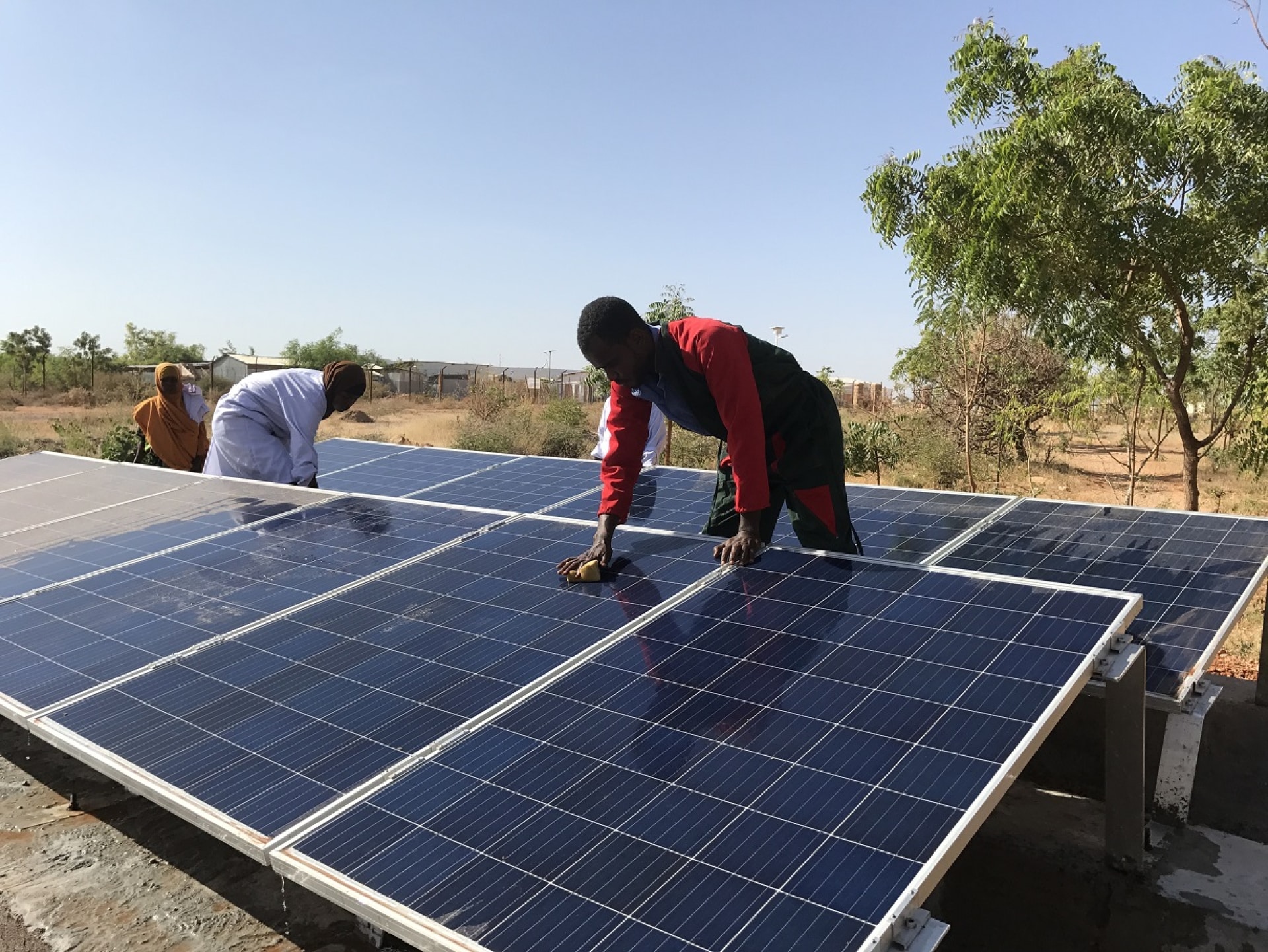 a group of men working on solar panels