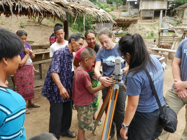 E306_Intro_Cal_Poly,_San_Luis_Obispo_Pa_Kloi,_Thailand_June_2015_teaching_the_community_members_how_to_set_up_and_use_a_theodolite_for_surveying.jpg