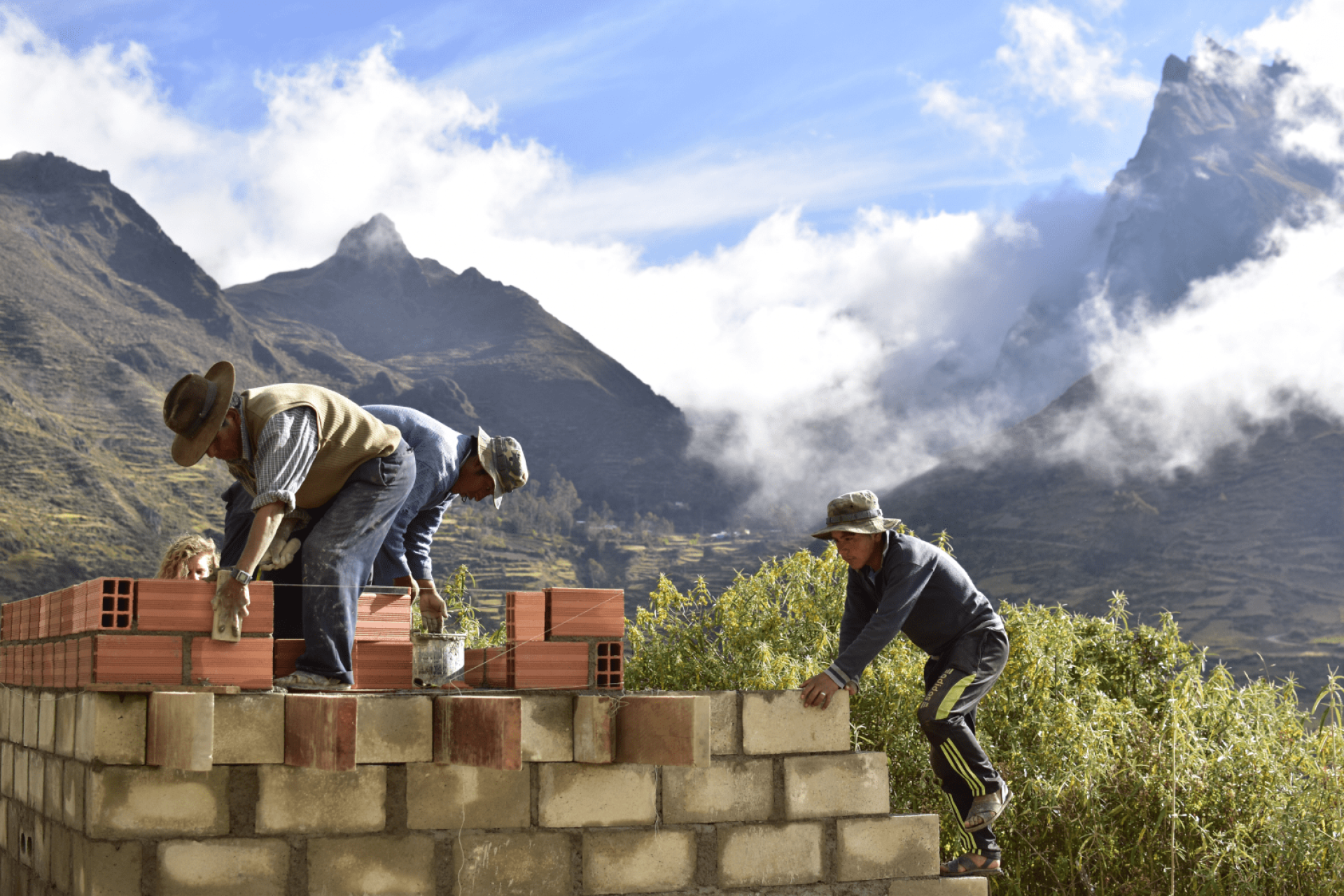 a group of men building a wall