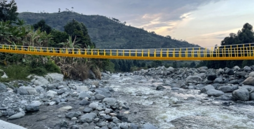 a yellow bridge over a river