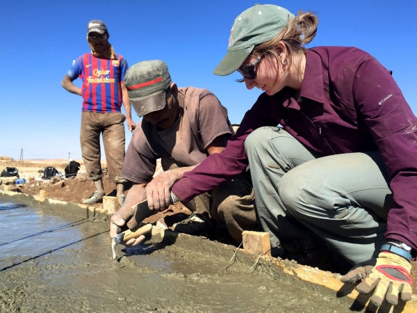 E309_Intro_Columbia_University_Water_Ilguiloda,_Morocco_Aug_2015_community_member_Mohammed_teaches_EWB-USA_Columbia_University_member_Madison_how_to_smooth_concrete-min.jpg