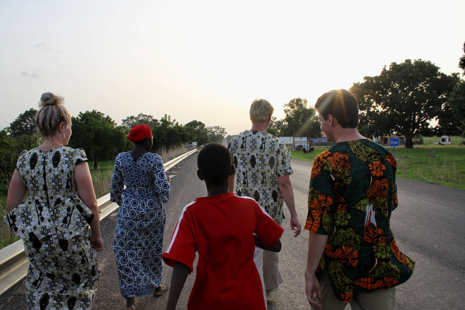 a group of people walking on a road